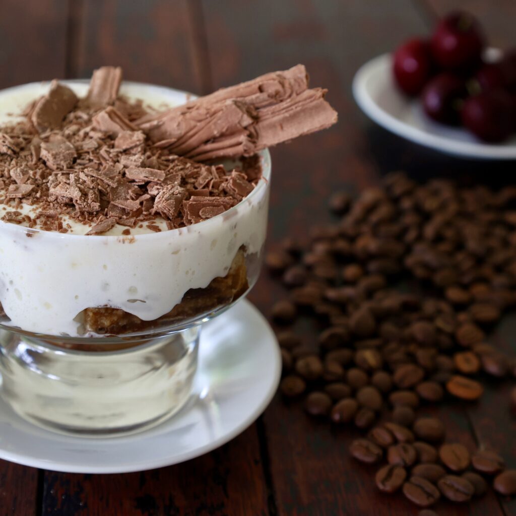 Tiramisu with coffee beans on table